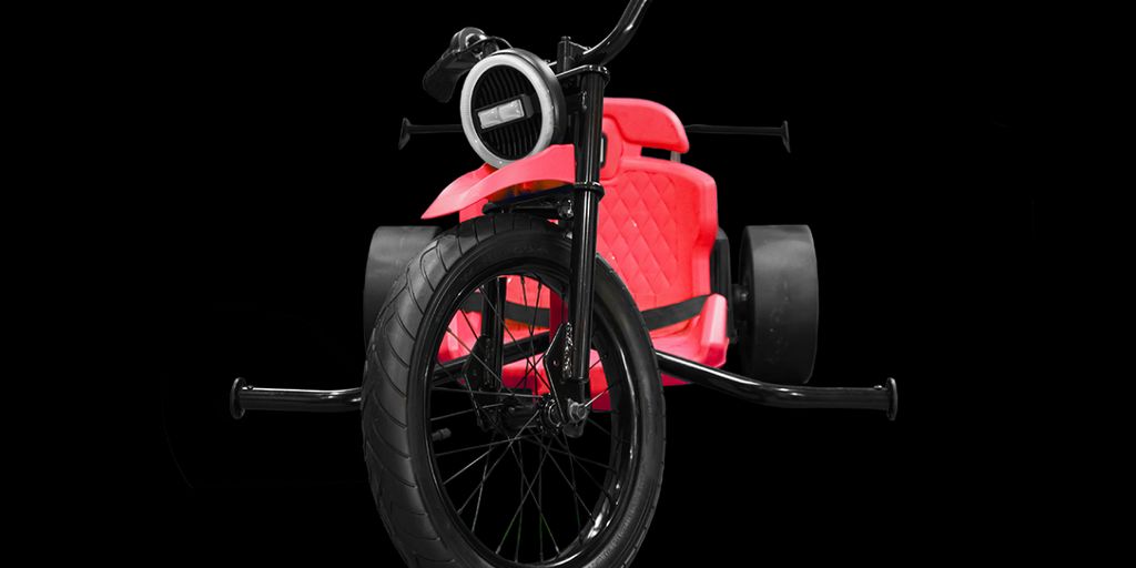 A futuristic-looking red tricycle with large black wheels.